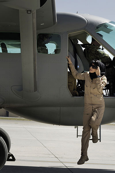 Afghan air force officer Niloofar Rhmani, accompanied by USAF 438th Air Expeditionary Advisory Group executive officer and AAF pilot advisor, deplanes Cessna 208 becoming first Afghan woman to fly fixed-wing combat mission (U.S. Air Force/Ben Bloker)