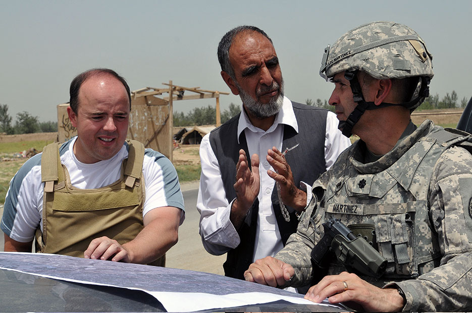 Chief engineer discusses power line construction with Kabul Electricity Directorate engineering liaison and U.S. State Department representative in Seh Du-kahn, Parwan Province (U.S. Navy/Tom Jones)