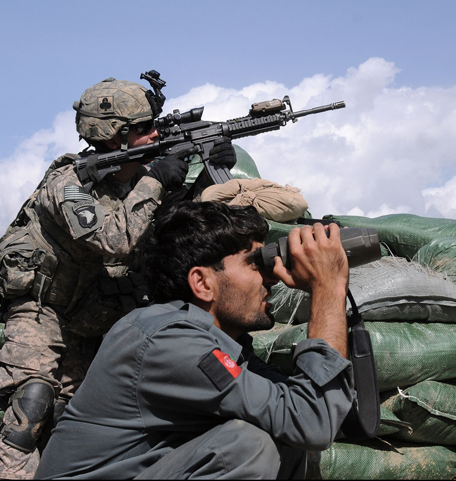 Solider and Afghan police officer search terrain in Kunar Province prior to firefight (U.S. Army/Gary A. Witte)