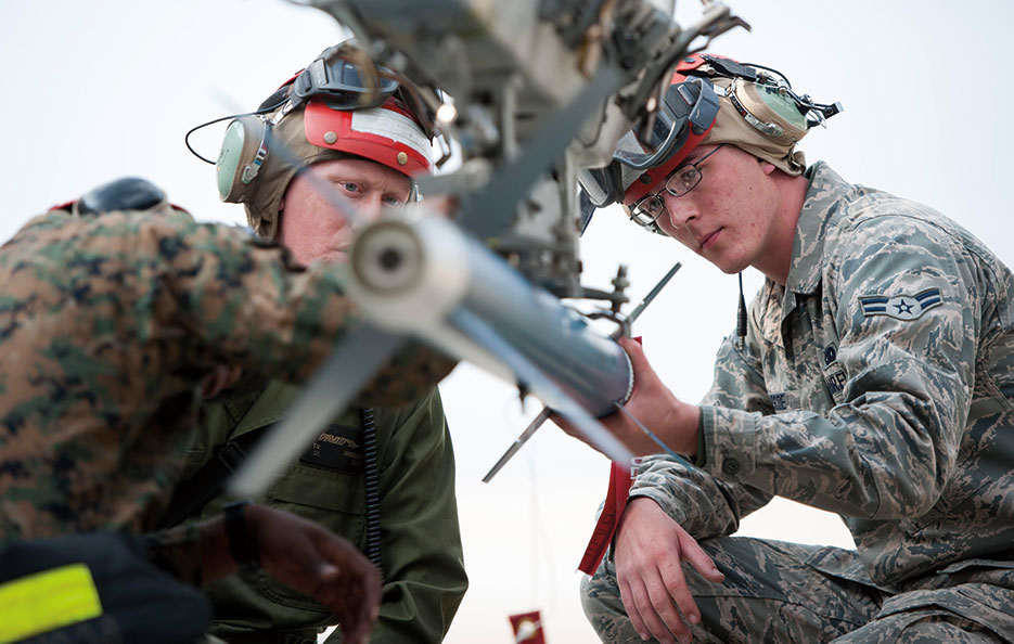 Airman helps Marine load missile at Kunsan Air Base, South Korea (U.S. Air Force/Armando A. Schwier-Morales)
