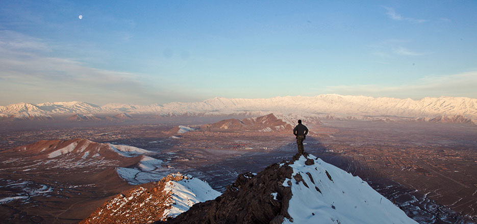Member of coalition force surveys terrain in Kabul Province, Afghanistan (U.S. Army/Matthew Freire)