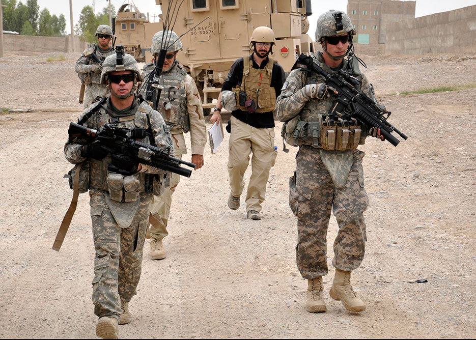 Kandahar PRT security force lead team member through Shur Andam Industrial Park in Kandahar City (U.S. Air Force /Richard Simonsen)