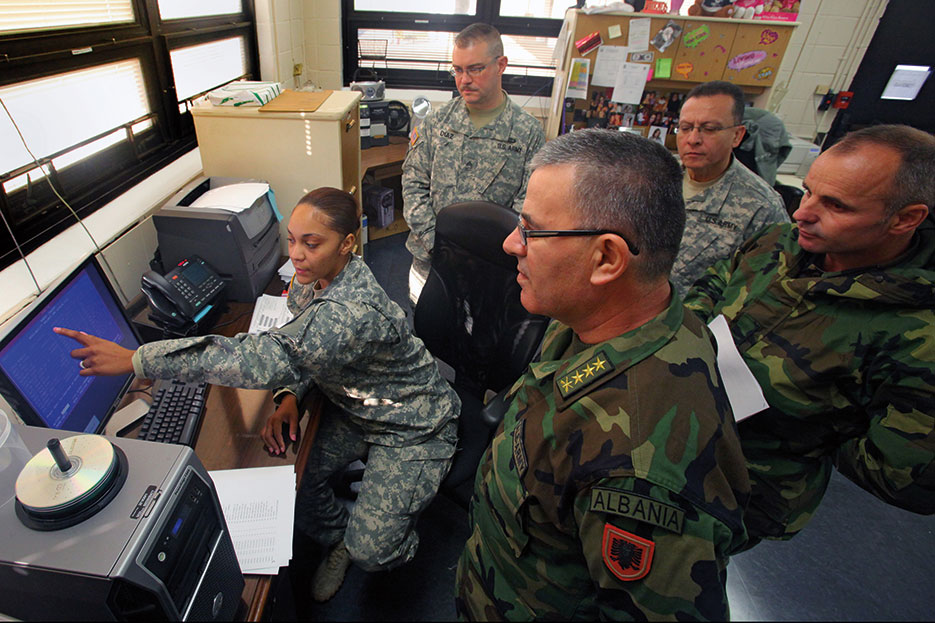 Army corporal explains Standard Army Retail Supply System to Albanian army officers at U.S. Property and Fiscal Office warehouse in Lawrenceville, New Jersey (U.S. Air Force/Mark Olsen)