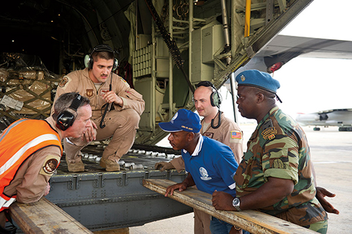 U.S. and Angolan airmen discuss unloading C-130J Super Hercules as part of African Partnership Flight with Angolan and Zambian air forces (U.S. Air Force/Benjamin Wilson)