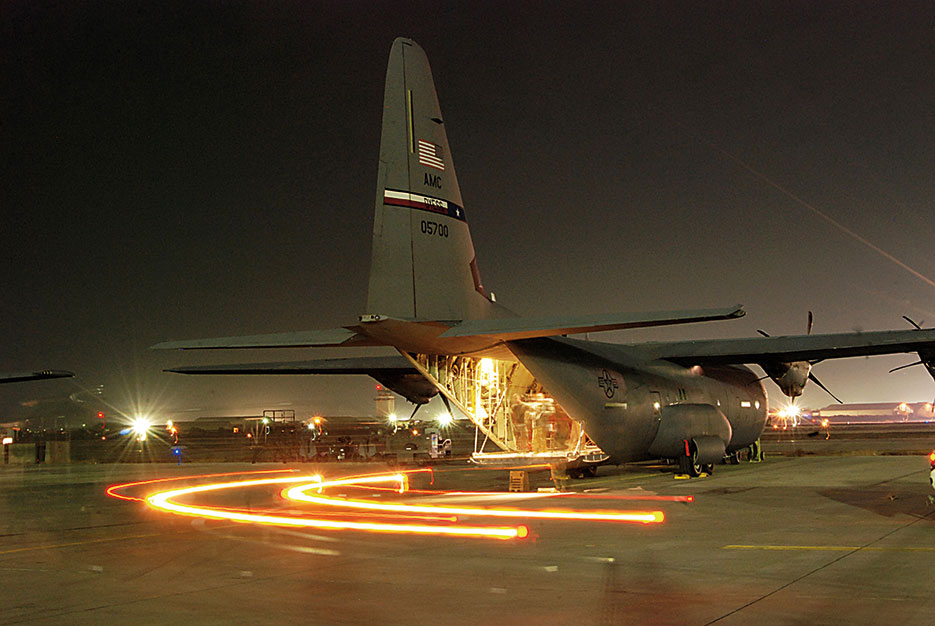 Halvorsen loader pulls away from C-130J Super Hercules at Bagram Air Field, Afghanistan, where Airmen from aerial port and airlift squadrons support operations 24/7 at DOD’s busiest single runway airfield (U.S. Air Force/Brian Wagner)