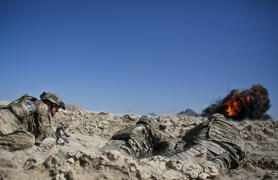 Asymmetric Warfare Group Advisor takes cover with Soldiers while man-portable line charge system is detonated during training exercise near Forward Operating Base Zangabad, Afghanistan (U.S. Army/Alex Flynn)