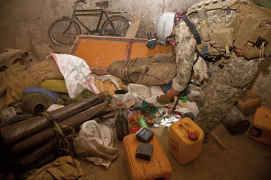 Afghan and coalition security force uncovers Taliban weapons cache containing materials for constructing IEDs, including ammonium nitrate, homemade explosives, and detonation triggers, during operation in Helmand Province (DOD/Justin Young)