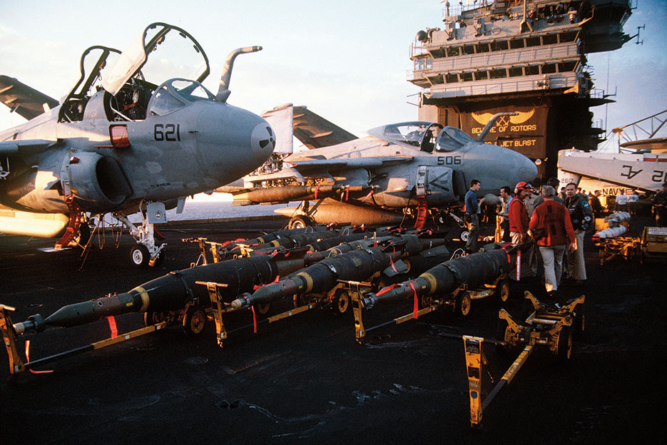 Laser-guided bombs line flight deck of aircraft carrier USS John F. Kennedy in preparation for air strikes against Iraq during Operation Desert Storm (PH2 Lipski)