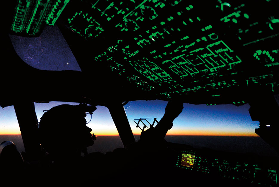 U.S. Air Force Captain Erica Stooksbury, a C-17 Globemaster III aircraft pilot with the 816th Expeditionary Airlift Squadron, adjusts cockpit lighting controls in C-17 over Iraq, August 2014 (DOD/Vernon Young, Jr.)