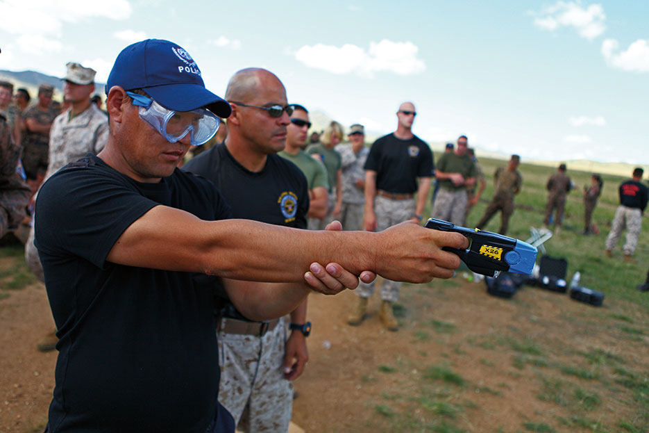 Mongolian police officer operates X26 taser during nonlethal weapons training at Five Hills Training Area, Mongolia, August 2013 (U.S. Marine Corps/Ben Eberle)
