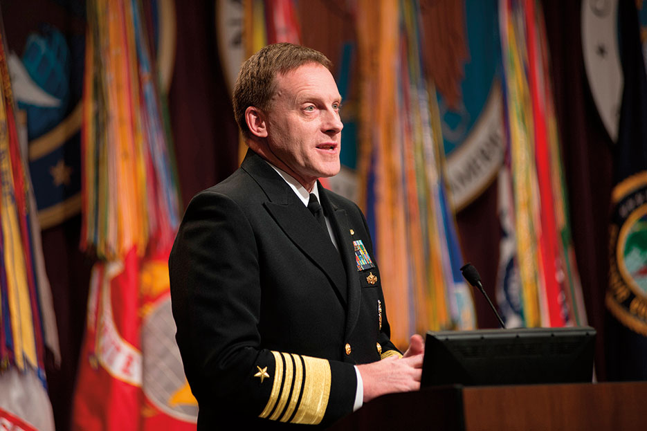 Admiral Michael Rogers addresses audience and workforces of U.S. Cyber Command, National Security Agency, and Central Security Service at his assumption of command ceremony, April 2014 (National Security Agency)