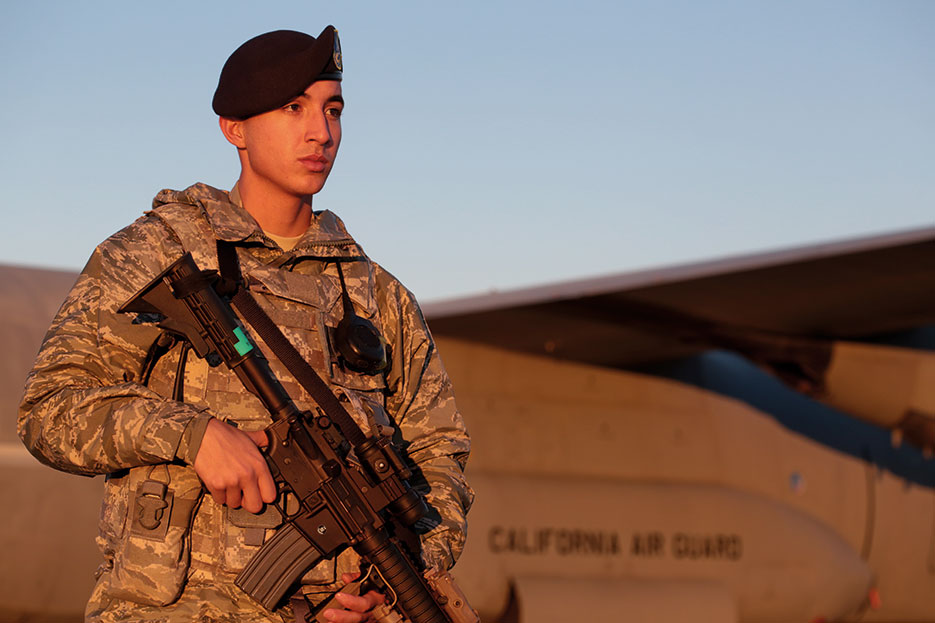 Airman walks perimeter of C-130J Hercules, November 2014 (U.S. Air National Guard/Matt Hecht)