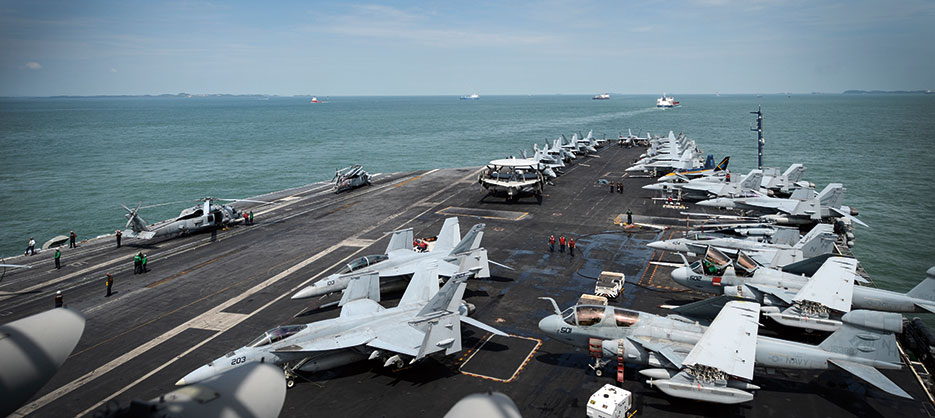 Sailors work on flight deck as aircraft carrier USS Nimitz, conducting maritime security operations and theater security cooperation efforts, transits Straits of Malacca (U.S. Navy/Derek A. Harkins)
