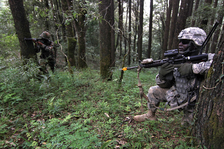 Cavalry scout and Indian army counterpart provide security for fellow soldiers during patrol through forests of Himalayas during exercise Yudh Abhyas (DOD/Mylinda DuRousseau)