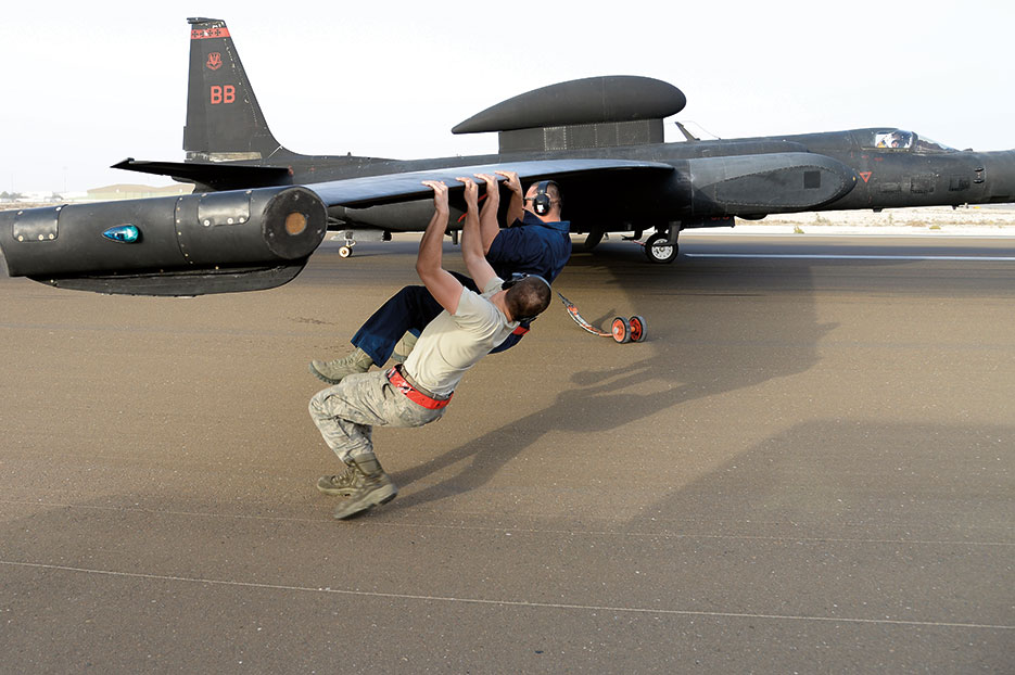 Airmen balance weight of U-2 Dragon Lady, which delivers critical imagery and signals intelligence to decisionmakers throughout all phases of conflict (U.S. Air Force/Marie Brown)