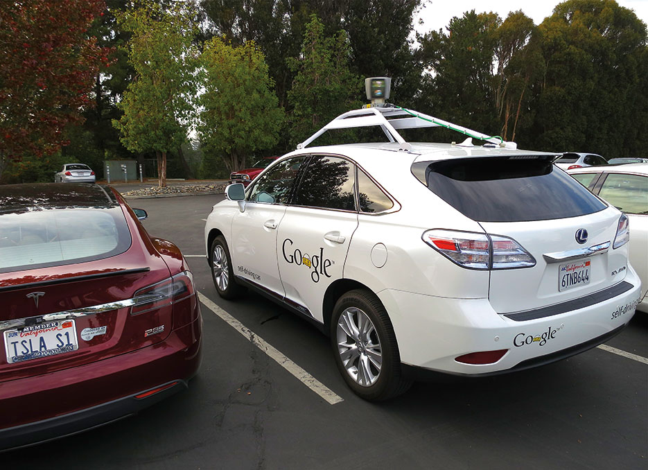 Lexus RX450h retrofitted by Google for its driverless car fleet parked near Tesla Model S electric car (Steve Jurvetson)