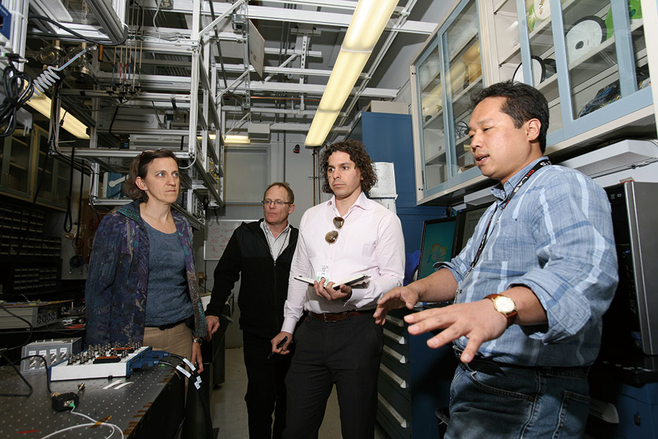 Sandia National Laboratories’ Daniel Soh, right, offers overview of continuous variable quantum key distribution lab (Dino Vournas)