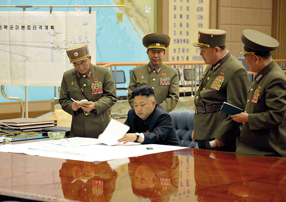 Kim Jong-un sitting at desk in what appears a dedicated military operations room (Korean Central News Agency)