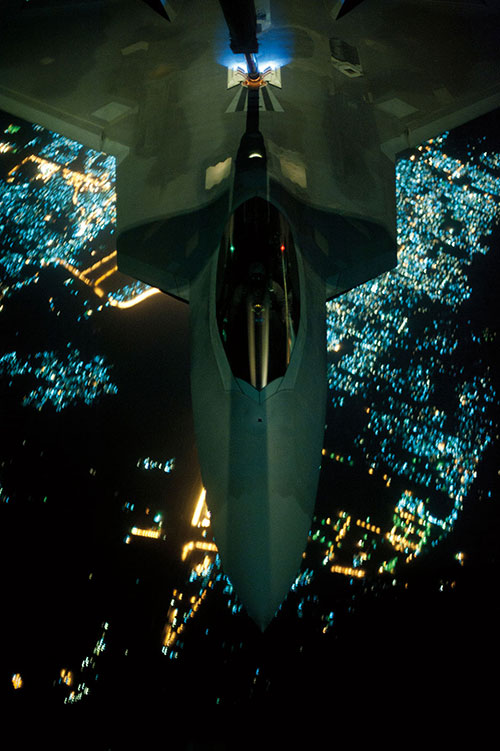 KC-10 Extender refuels F-22 Raptor over undisclosed location before targeted airstrikes in Syria to protect U.S. personnel from Islamic State in Iraq and Levant (DOD/Russ Scalf)