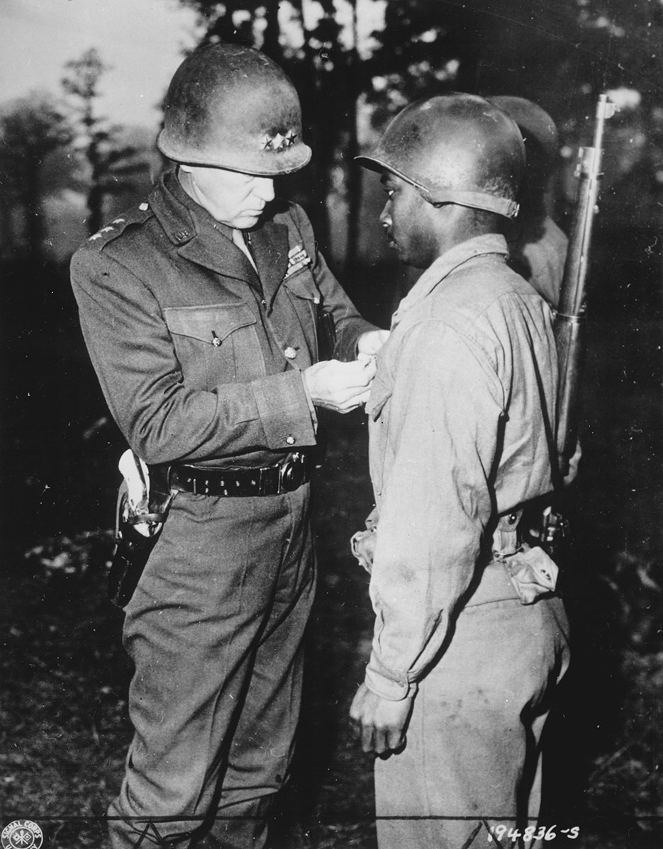 Lieutenant General George S. Patton, U.S. Third Army commander, pins Silver Star on Private Ernest A. Jenkins of New York City (NARA)
