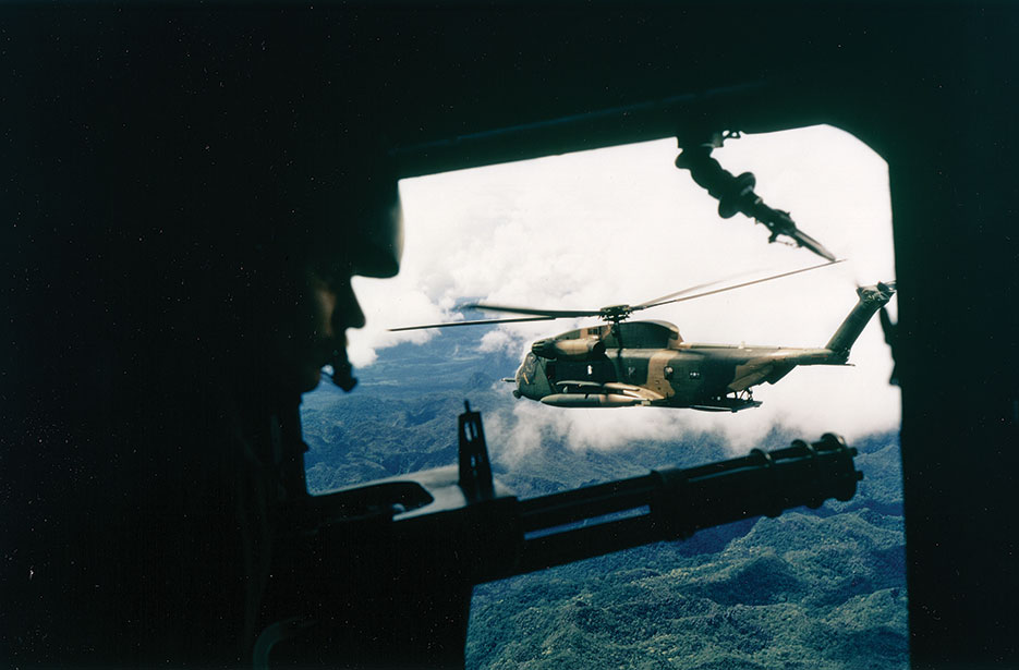 Side view of HH-53 helicopter of 40th Aerospace Rescue and Recovery Squadron as seen from gunner’s position on A-1 of 21st Specialist Operations Squadron (U.S. Air Force)
