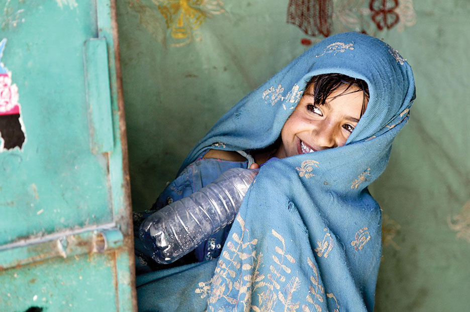 Afghan girl peeks around door as U.S. Special Forces and Cultural Support Team speak with her father, Uruzgan Province (DOD/Kaily Brown)