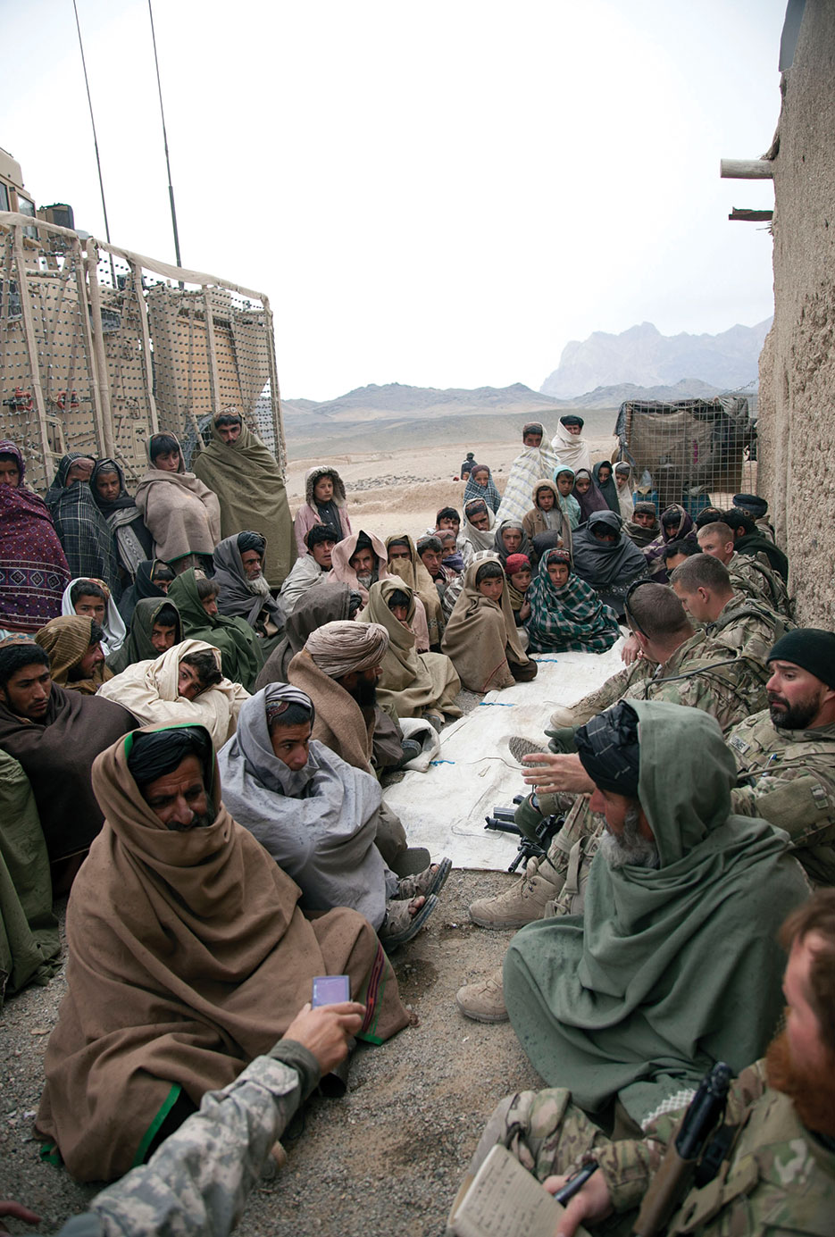 Soldiers from Charlie Troop, 2-38 Cavalry, and DA civilians, Human Terrain System, with local Afghan villagers during Key Leader Engagement in Kandahar Province (DOD/Crystal Davis)