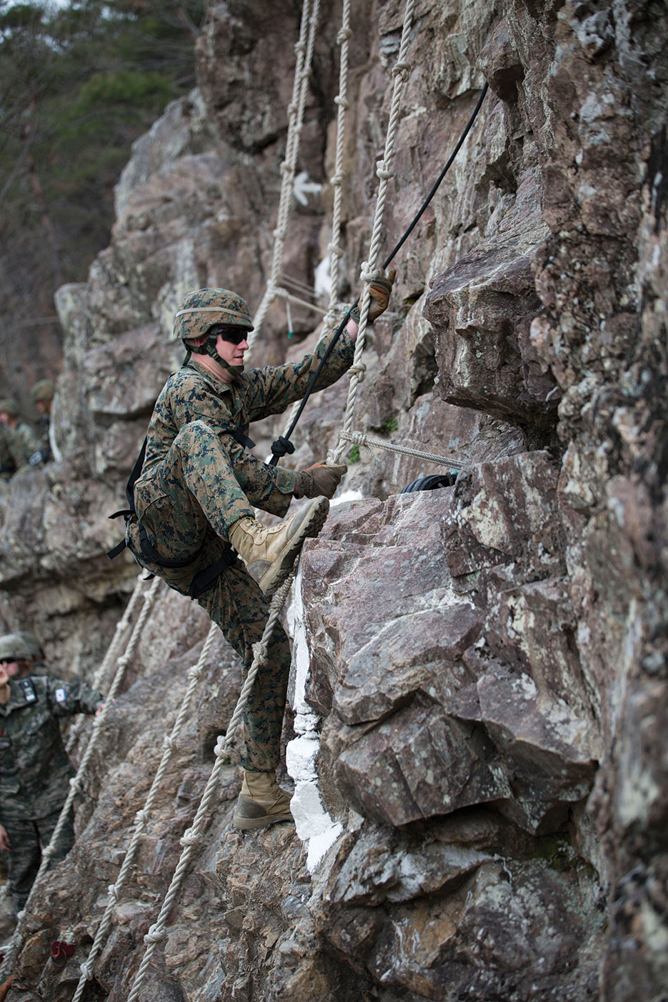 U.S. Marine Corps field radio operator climbs mountainside during mountain warfare training course as part of Marine Expeditionary Force Exercise MEFEX 2014 in Pohang, South Korea (DOD/Cedric R. Haller II)