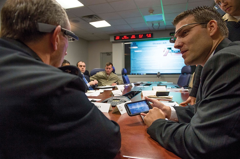 Dr. Josh Kvavle, right, demonstrates Google Glass headset for Chief of Naval Operations Admiral Jonathan Greenert during Rapid Innovation Cell meeting (U.S. Navy/Peter D. Lawlor)