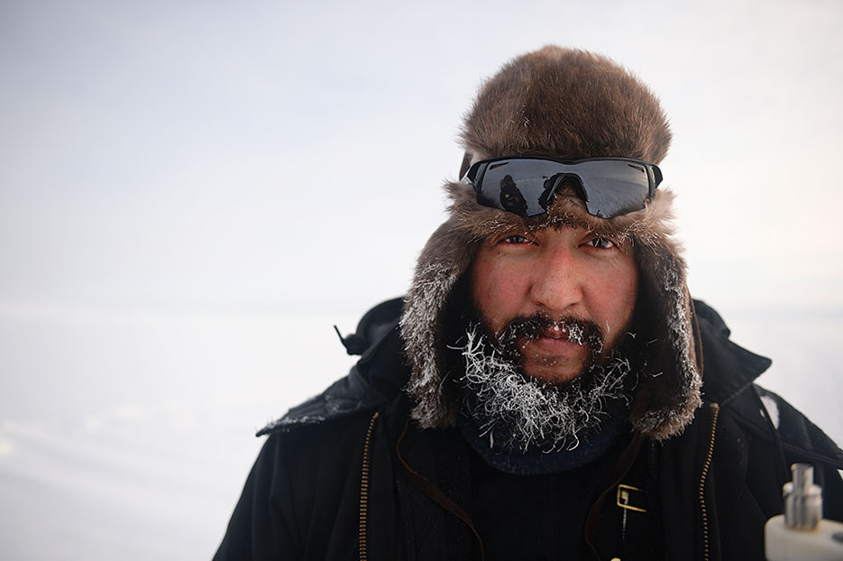 U.S. Navy Arctic Submarine laboratory technician takes break from preparing submarine surfacing site near Ice Camp Nautilus in Arctic Ocean during Ice Exercise 2014 (DOD/Joshua Davies)