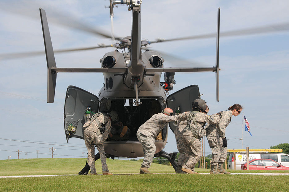 Army and Air National Guardsmen carefully exit helicopter pad during PATRIOT Exercise 2015 at Mile Bluff Medical Center in Mauston, Wisconsin, July 2015 (U.S. Air National Guard/Paul Mann)