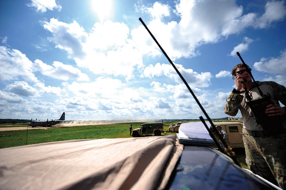 Senior Airman from 21st Special Tactics Squadron conducts air traffic control operations on edge of Geronimo Landing Zone at Fort Polk, Louisiana, during Joint Readiness Training Center rotation 13-09, August 2013 (U.S. Air Force/Parker Gyokeres)