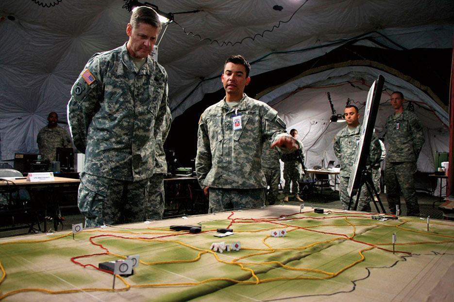 Intelligence analyst gives commander of 21st Theater Sustainment Command terrain brief of Hohenfels Training Area on enemy activity (U.S. Army/Henry Chan)
