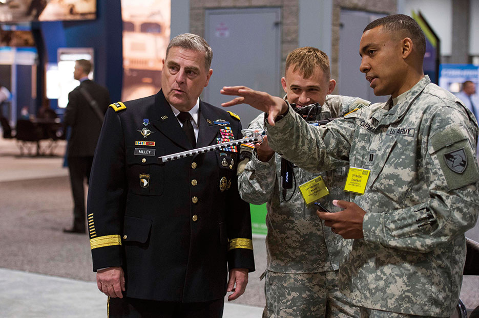U.S. Army Chief of Staff General Mark Milley watches officers from Army Cyber Institute demonstrate Cyber Capability Rifle during 2015 Association of the U.S. Army annual meeting, Washington, DC (U.S. Army/Chuck Burden)