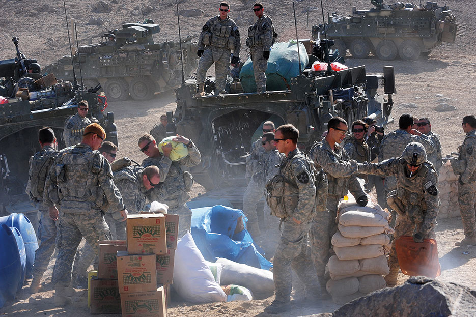 U.S. Soldiers assigned to Company C, 1st Battalion, 17th Regiment, unload humanitarian aid for distribution to town of Rajan Kala, Afghanistan, December 5, 2009 (U.S. Air Force/Francisco V. Govea II)
