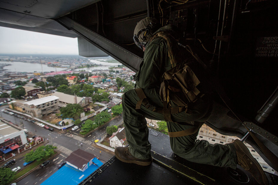 U.S. Marine assigned to Special-Purpose Marine Air-Ground Task Force Crisis Response–Africa prepares to land at U.S. Embassy in Monrovia to support Operation United Assistance in Liberia, October 13, 2014 (U.S. Marine Corps/Andre Dakis)