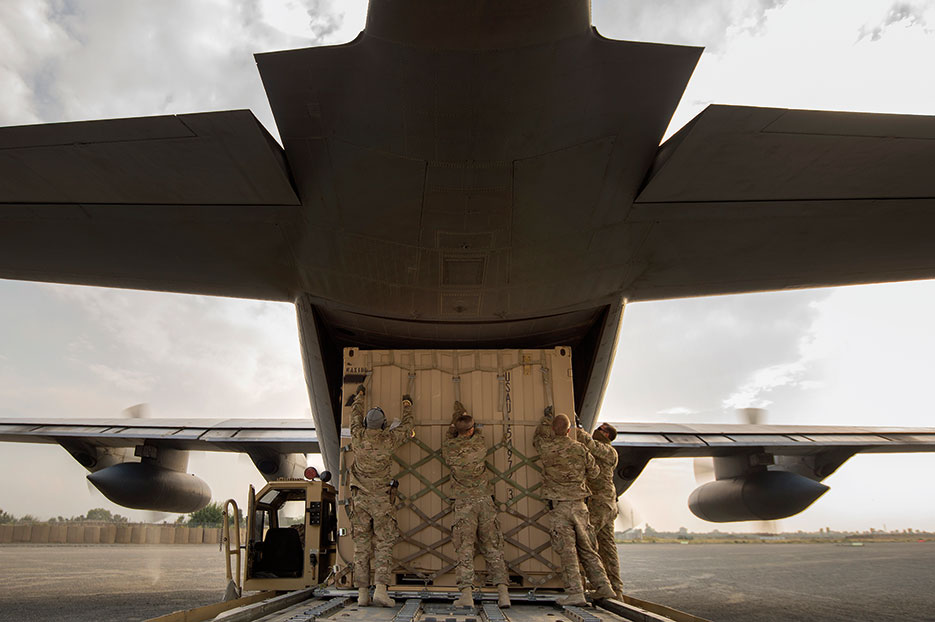 Aerial porters from 19th Movement Control Team prep shipping container for 774th Expeditionary Airlift Squadron C-130 Hercules cargo plane at Forward Operating Base Salerno, Khost Province, Afghanistan, September 22, 2013 (U.S. Air Force/Ben Bloker)