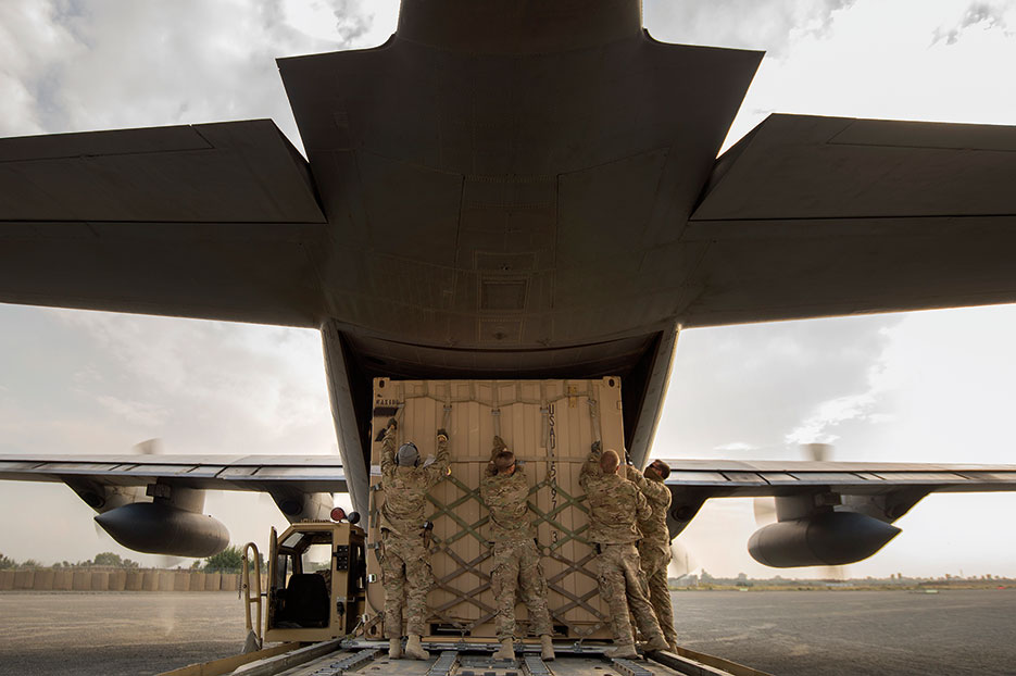 Aerial porters from 19th Movement Control Team prep shipping container for 774th Expeditionary Airlift Squadron C-130 Hercules cargo plane at Forward
Operating Base Salerno, Khost Province, Afghanistan, September 22, 2013 (U.S. Air Force/Ben Bloker)