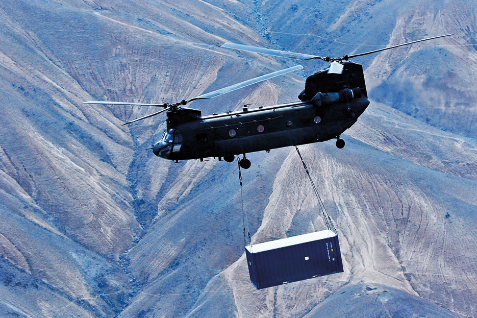U.S. Army CH-47 Chinook helicopter operated by Soldiers with Texas and Oklahoma Army National Guard units carries sling-loaded shipping container during retrograde operations and base closures in Wardak Province, Afghanistan, October 26, 2013 (U.S. Army/Peter Smedberg)