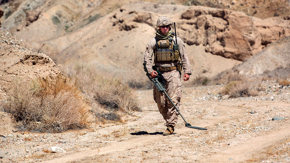 Explosive ordnance disposal technician, 3rd EOD, 9th Engineer Support Battalion, performs sweep with metal detector during post-blast analysis training scenario at Emerson Lake training area, September 19, 2015, Twentynine Palms California (U.S. Marine Corps/Levi Schultz)