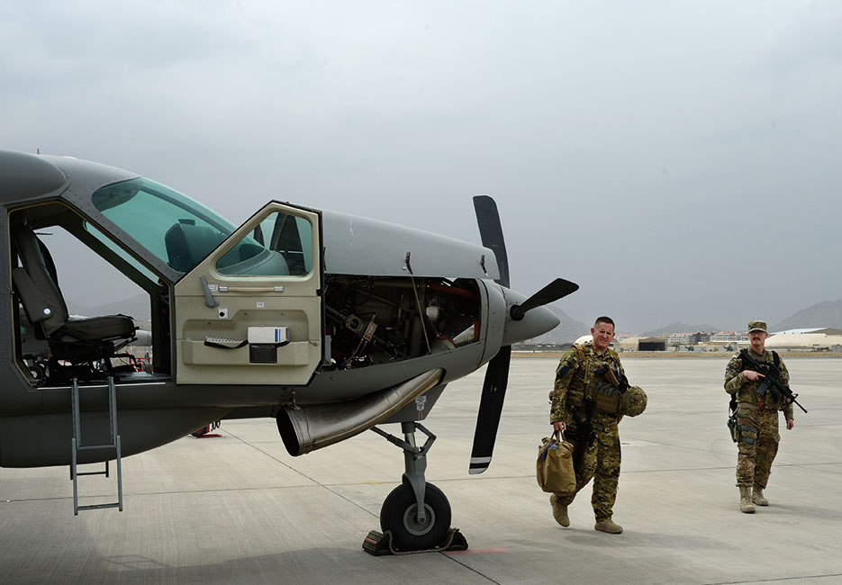 U.S. Air Force Train, Advise, Assist Command–Air advisor pilot and guardian angel Airman and Afghan air force pilot after training flight on Cessna C-208, September 21, 2015 (U.S. Air Force/Sandra Welch)