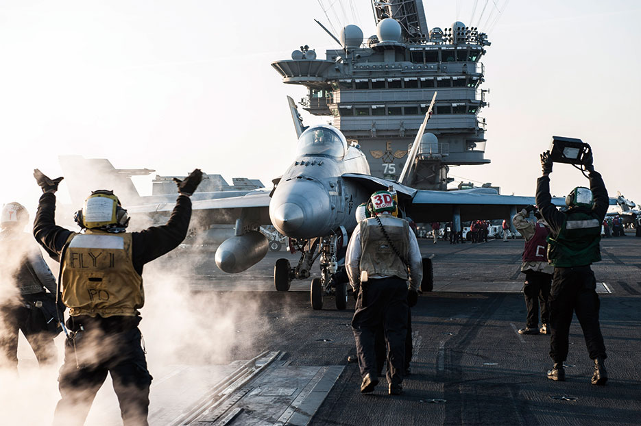Sailors direct F/A-18C Hornet from Strike Fighter Squadron (VFA) 83 on flight deck of USS <i>Harry S. Truman</i> (CVN 75) in U.S. 5<sup>th</sup> Fleet area of operations in Arabian Gulf, February 2016 (U.S. Navy/Lindsay A. Preston)
