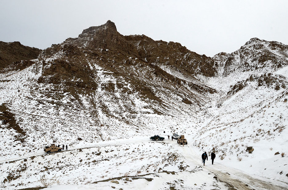 Afghan police officers and Afghan National Security Forces move up mountain pass in Paktika Province, Afghanistan, January 2014 (DOD/Jared Gehmann)