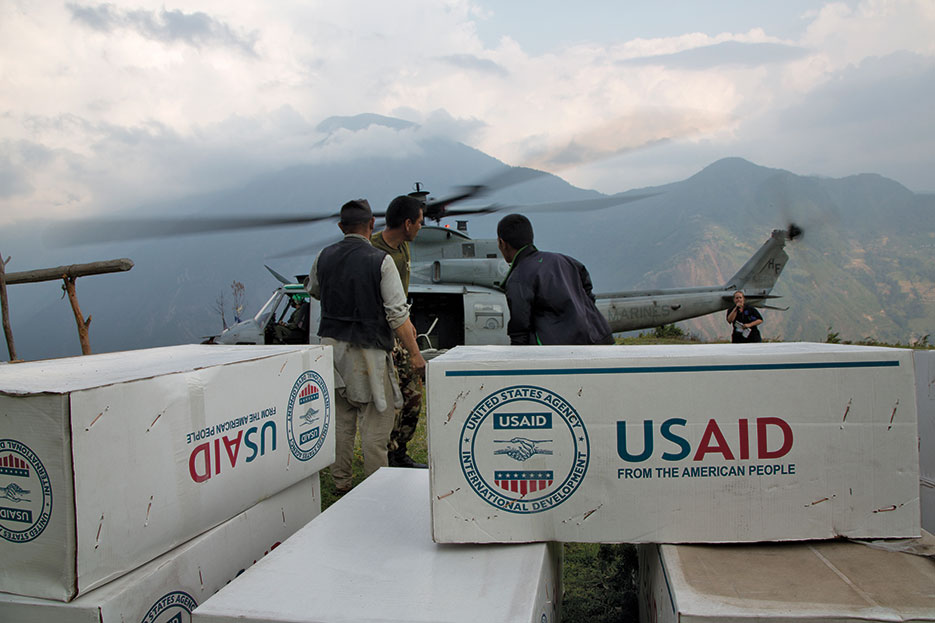 Relief supplies from USAID unloaded off Marine Corps UH-1Y Venom from Joint Task Force 505 in remote area of Nepal during Operation <i>Sahayogi Haat</i> (U.S. Marine Corps/Hernan Vidana)
