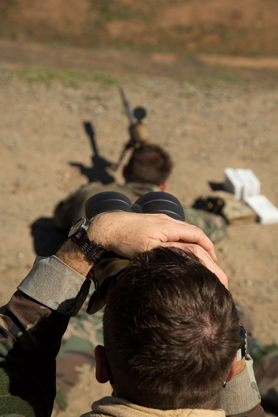 Marine spots for his teammate, who is firing at distant, static targets on range aboard Marine Corps Base Camp Pendleton, California, October 2015 (U.S. Marine Corps)