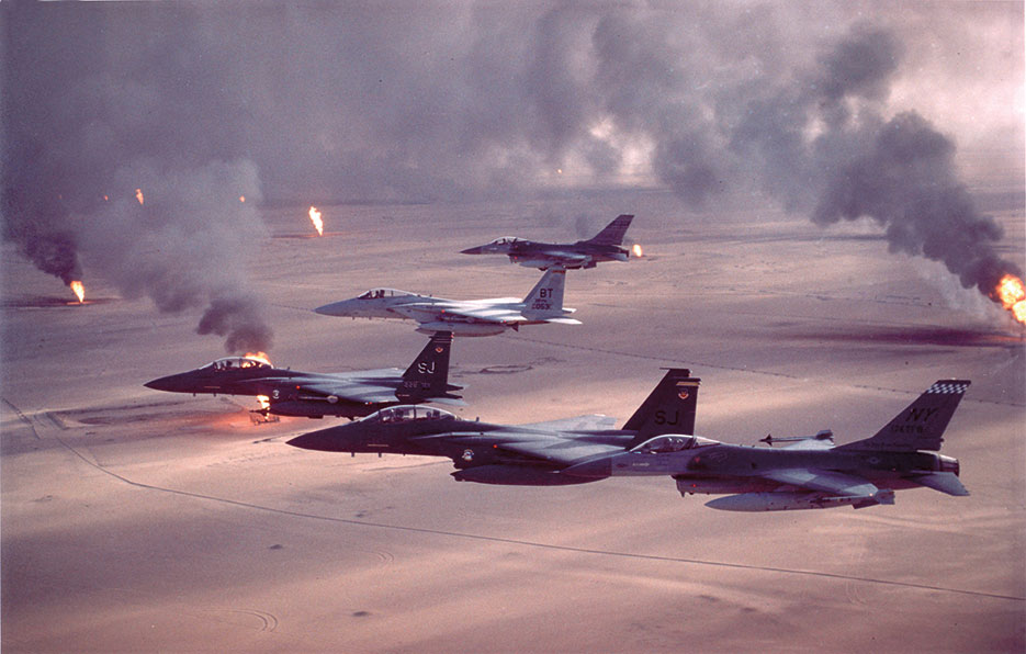 Air Force F-16A Fighting Falcon, F-15C Eagle, and F-15E Strike Eagle fighter aircraft fly over burning oil field sites in Kuwait during Operation <i>Desert Storm</i> (U.S. Air Force)