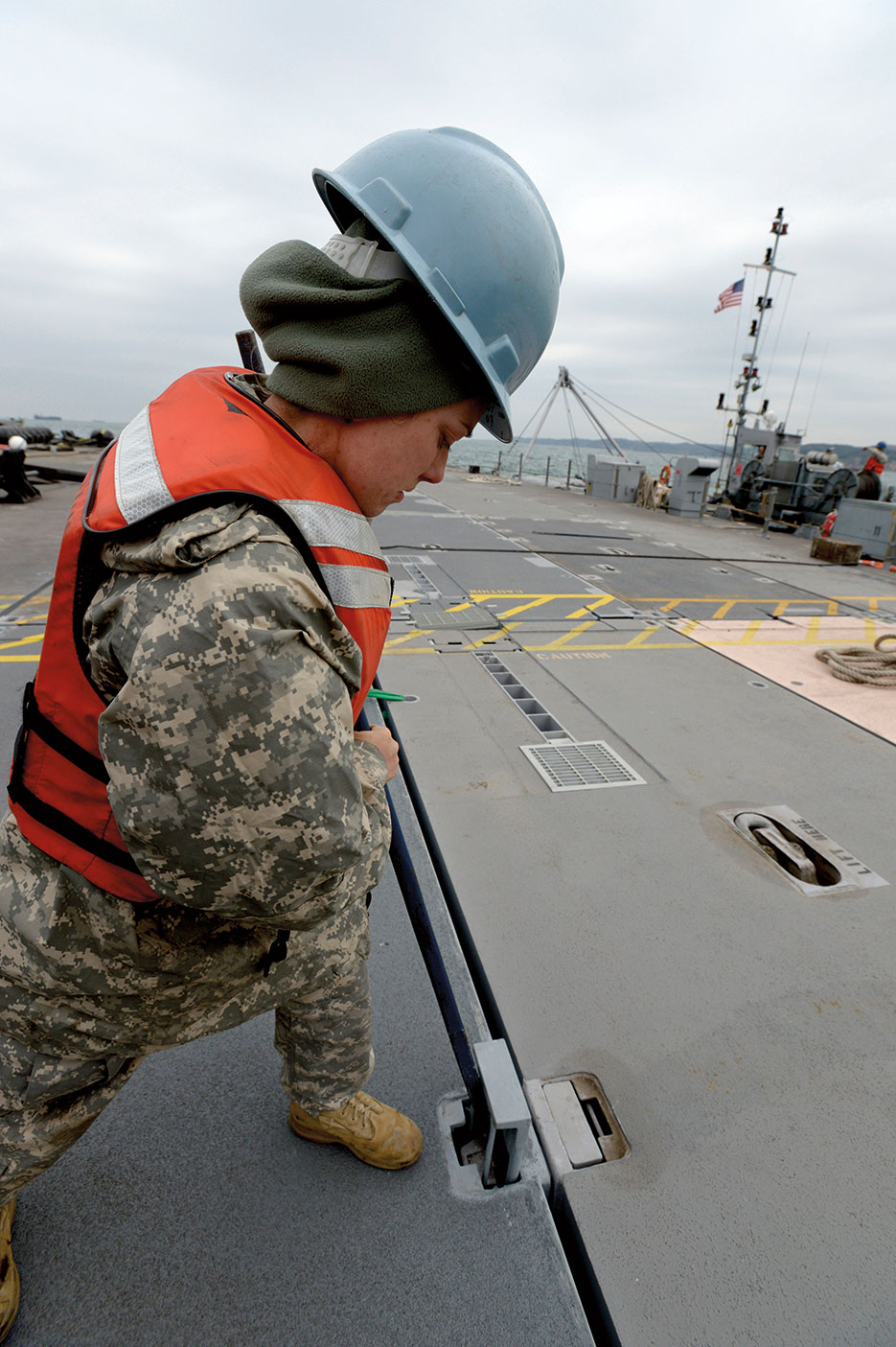 Soldier assigned to 331st Transportation Company locks in portion of Trident pier during Combined/Joint Logistics Over-the-Shore naval exercise on Korean Peninsula, April 15, 2013, intended to improve logistics interoperability, communication, and cooperation between the United States and South Korea (U.S. Navy/Elisandro T. Diaz)