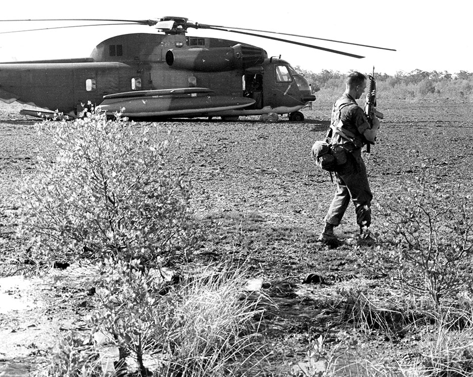 Marine captain prepares to fire on and destroy important equipment on disabled HH-53 to prevent its capture by Cambodians (U.S. Air Force/Ronald T. Rand)