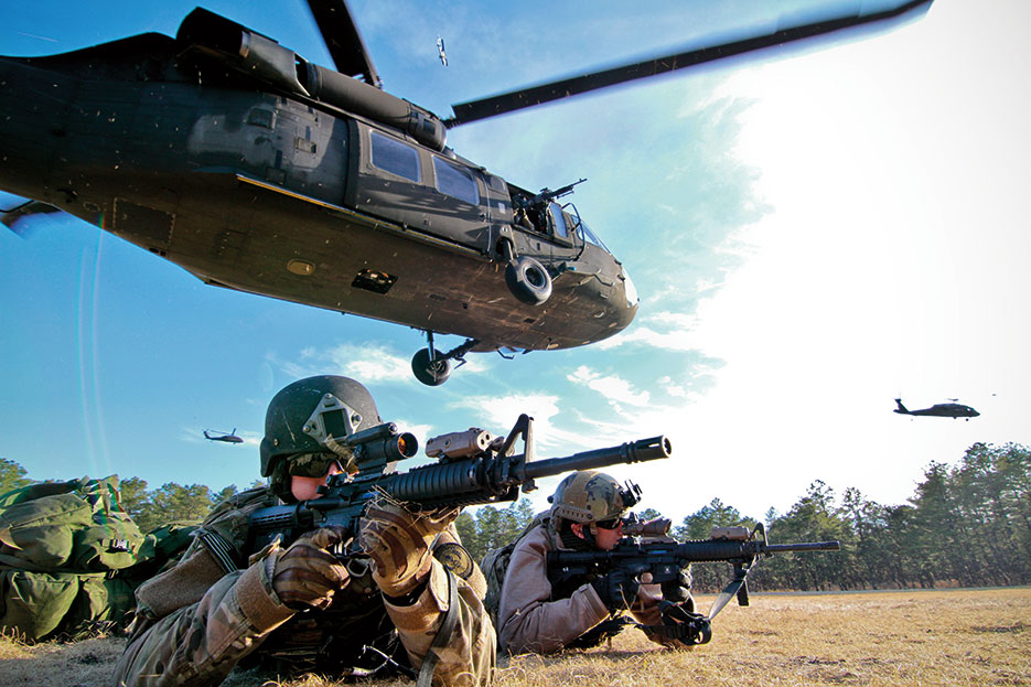 Servicemembers provide cover after tactical air insertion with Army UH-60 Black Hawk helicopter at Fort Dix, New Jersey, April 10, 2014 (U.S. Air National Guard/Matt Hecht)