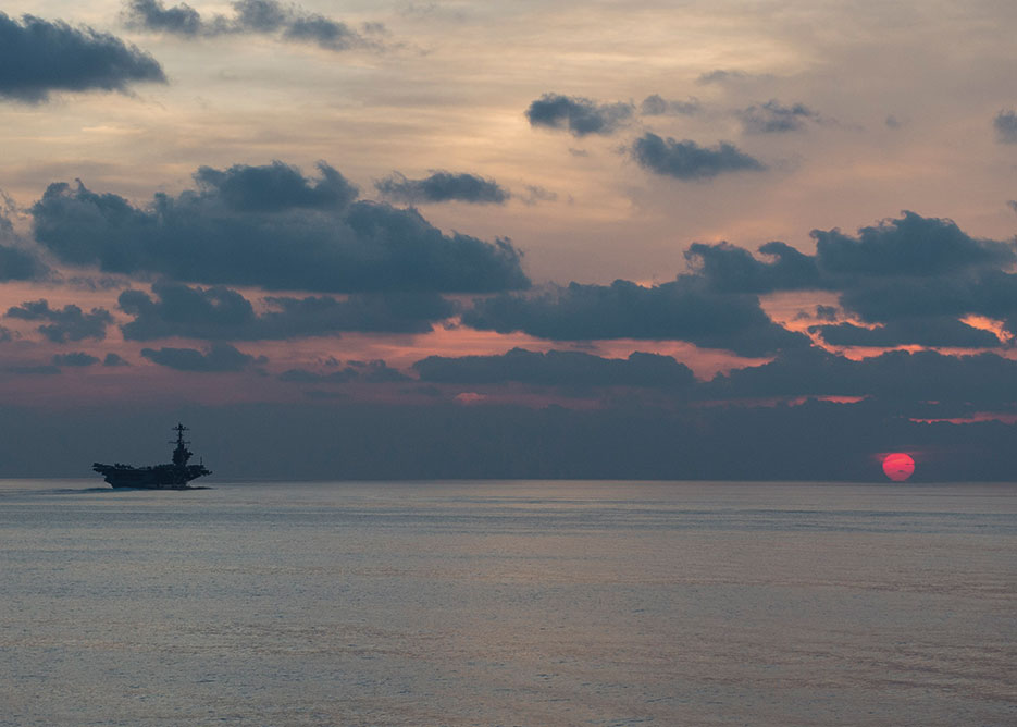 USS John C. Stennis steams at dusk in South China Sea, supporting security and stability in Indo-Asia Pacific, April 25, 2016 (U.S. Navy/Emiline L.M. Senn)